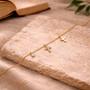 Collier croix grappe de cristaux dorée